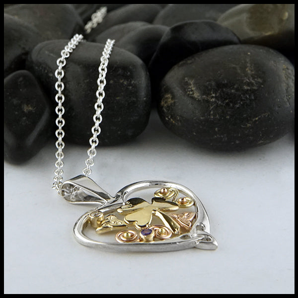 Profile view of Custom shamrock heart pendant in silver and gold with sapphire and diamond