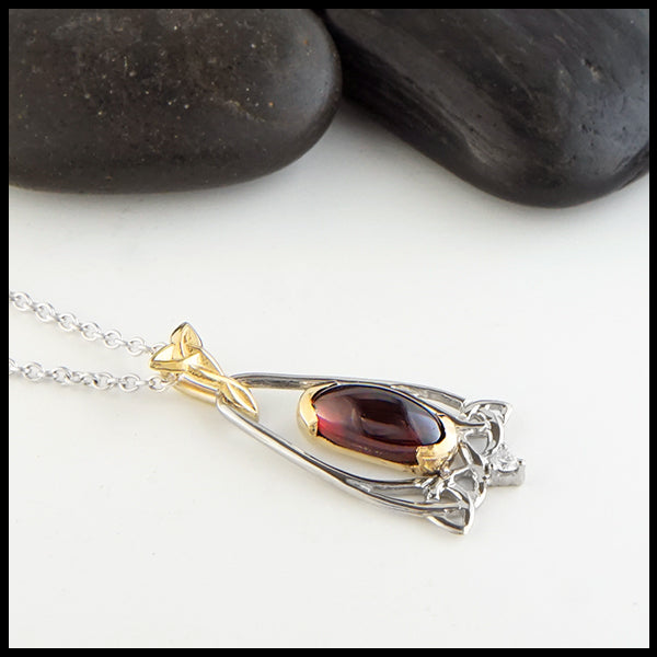 Profile view Oval Garnet and Trinity Knot Gold Pendant