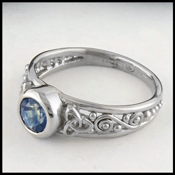 Profile view of Montana Sapphire and Trinity Knot Gold Ring