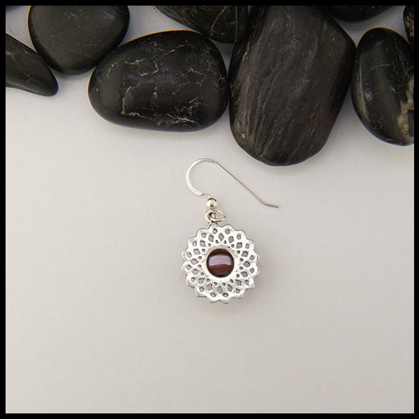 Rear view of celtic knot flower earrings with red garnet