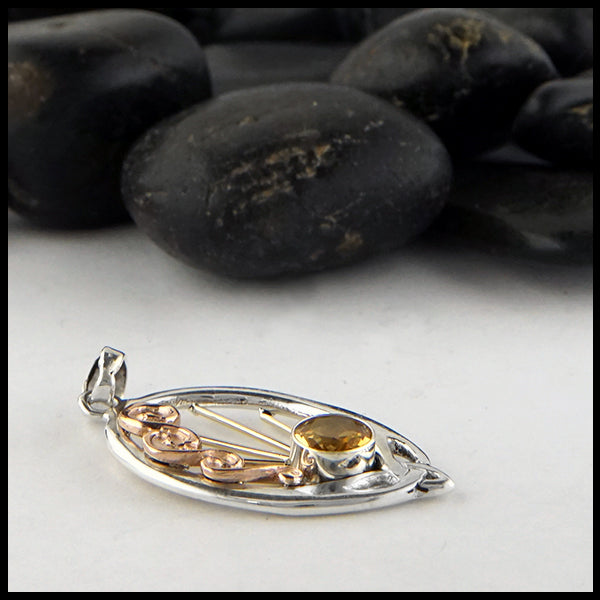 profile view of silver and gold citrine pendant