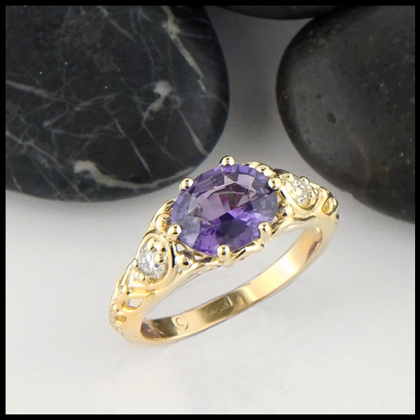 Premium Photo | A gold ring with purple and blue stones and a purple diamond .