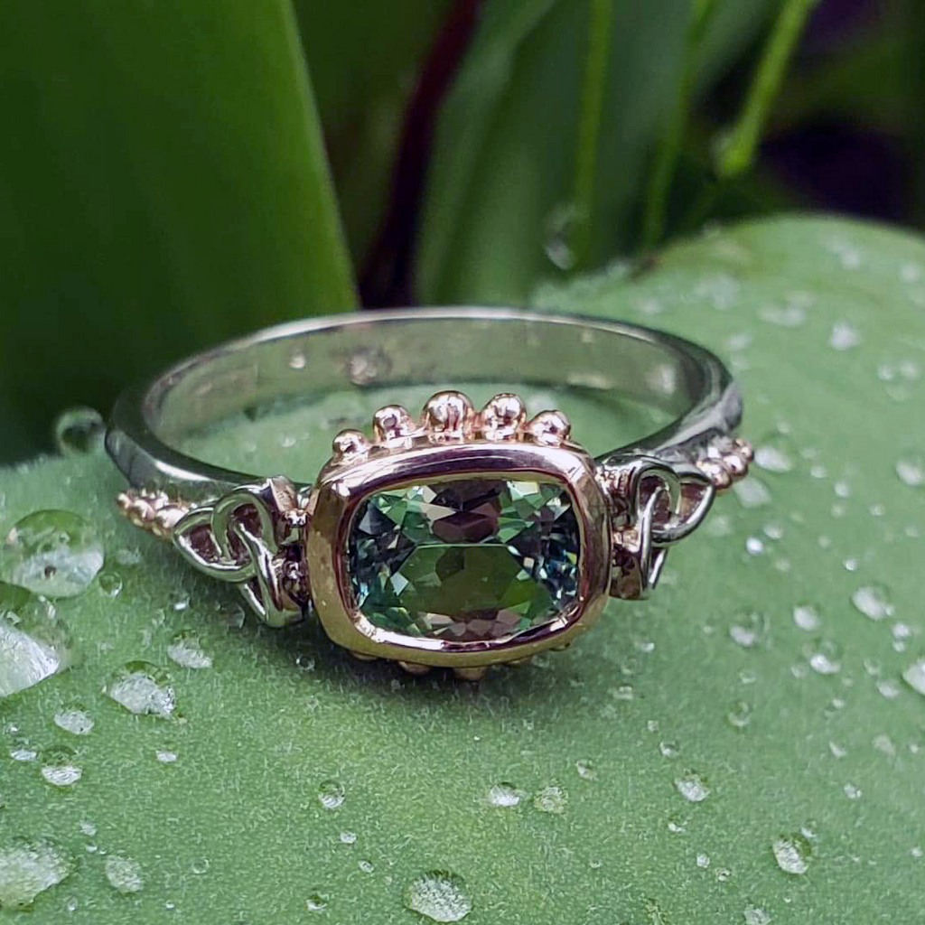 This Mint Garnet is set in a 14K Yellow and Rose Gold frame