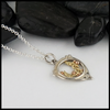 Custom Celtic flourish pendant in silver and gold