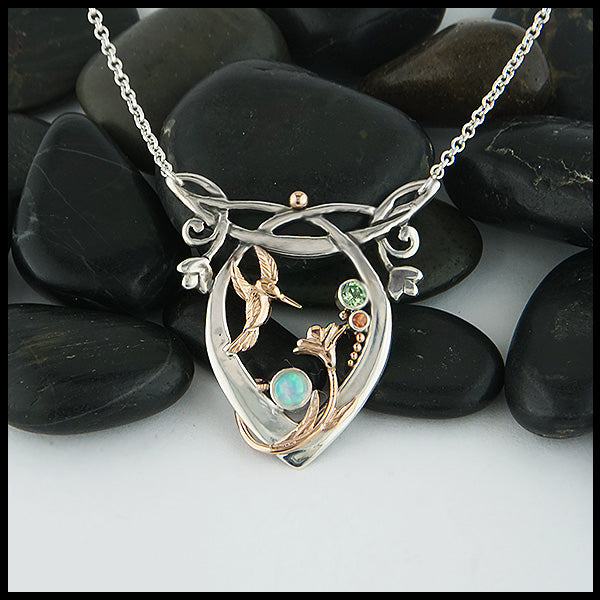 Custom Whimsical Hummingbird pendant in Sterling Silver, with 14K Rose Gold hummingbird, flower, and accent beads, set with an Opal, Mint Garnet and a dainty Rhodolite Garnet.