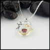 Sterling silver hummingbird pendant with raspberry  tourmaline and yellow gold accents